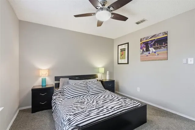 a bedroom with a bed and a ceiling fan