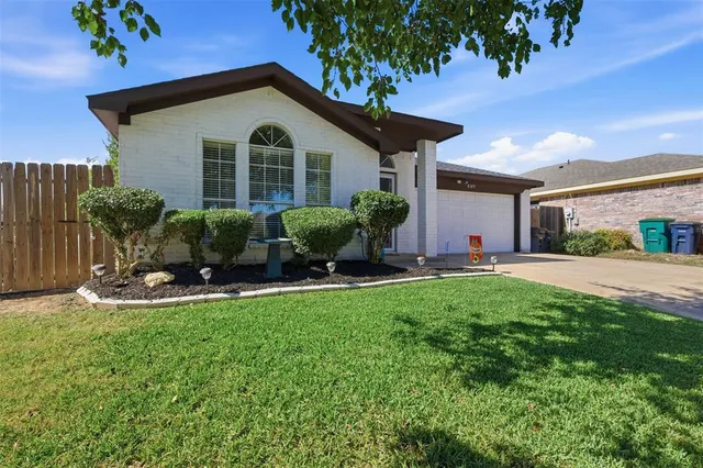 a front view of house with yard and outdoor seating