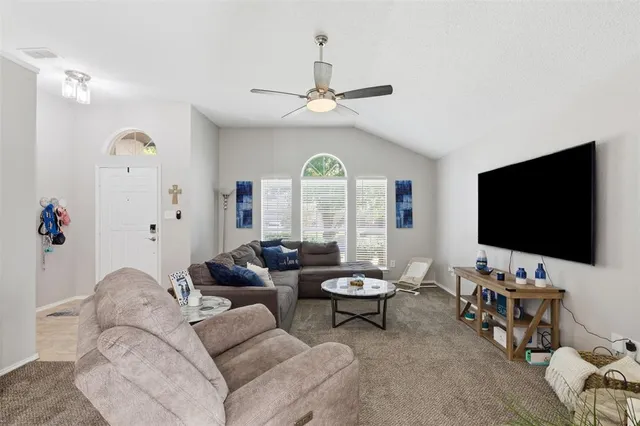 a living room with furniture a fireplace and a flat screen tv