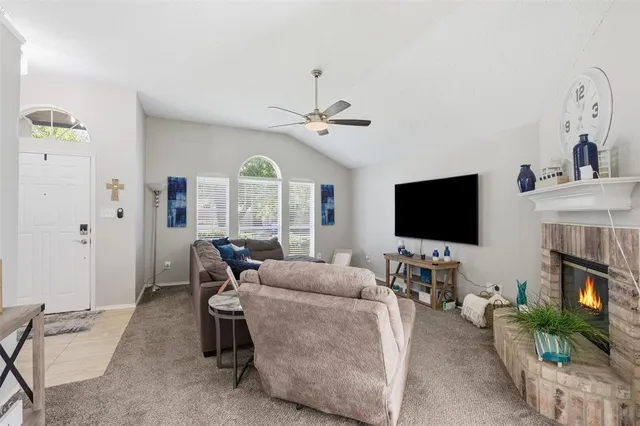 a living room with furniture a fireplace and a flat screen tv