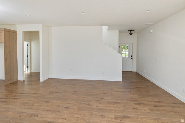 612 North 400 West Logan, UT 84321 - Photo 13 of 27 Expansive open-concept living space featuring wood-finish flooring, crisp white walls, and recessed lighting