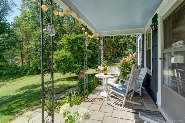 a view of yard from deck with patio