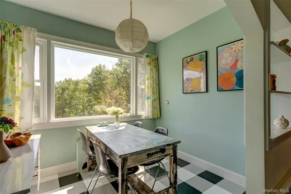 a view of a dining room with furniture wooden floor and a chandelier