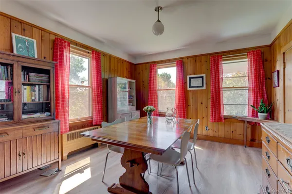 a view of a dining room with furniture and window