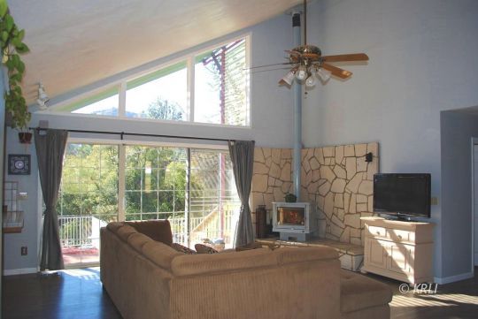 595 Evans Road Wofford Heights, CA 93285 - Photo 7 of 43 a living room with fireplace furniture and a flat screen tv