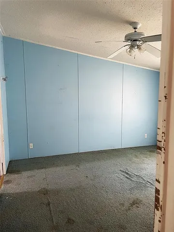 an empty room with a ceiling fan