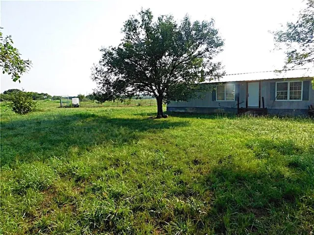 a backyard of a house with lots of green space