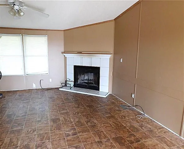 a view of empty room with a fireplace