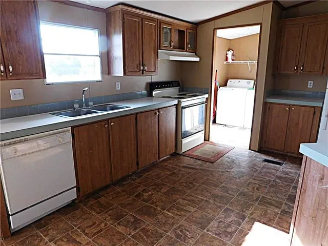 a kitchen with stainless steel appliances a sink stove and window