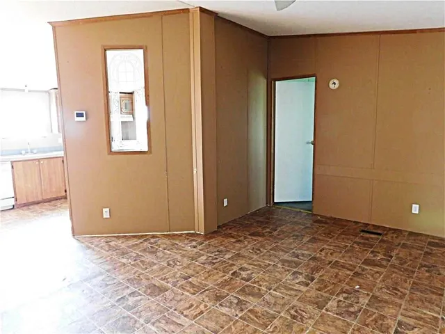 a view of a room with a wooden door