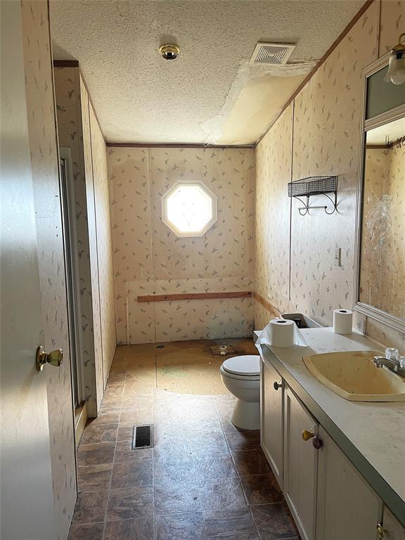 105 Apache Road Brownwood, TX 76801 - Photo 10 of 24 a bathroom with a sink a toilet and mirror