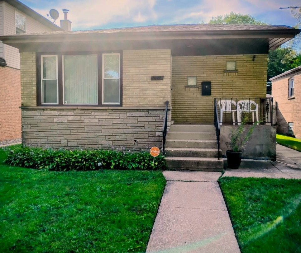 12346 South Indiana Avenue Chicago, IL 60628 - Photo 1 of 14 a front view of a house with garden