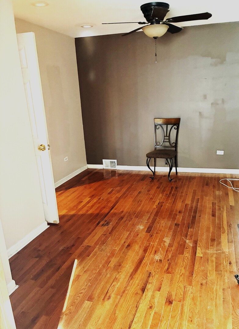 12346 South Indiana Avenue Chicago, IL 60628 - Photo 6 of 14 a view of a room with wooden floor and chair