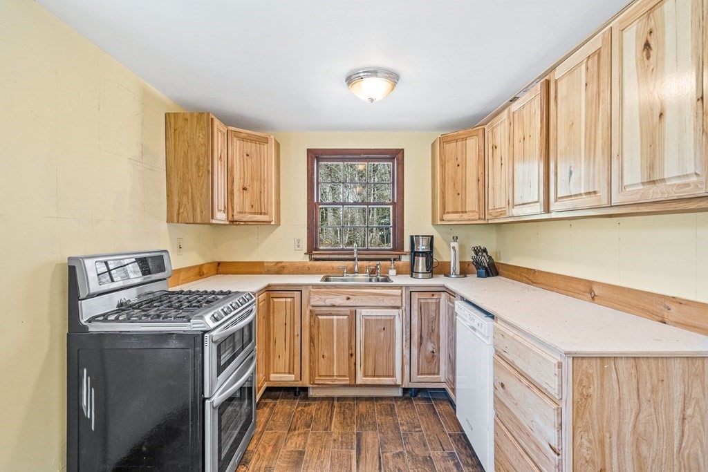 89 Willow Road Boxford, MA 01921 - Photo 1 of 22 a kitchen with a sink stove and cabinets