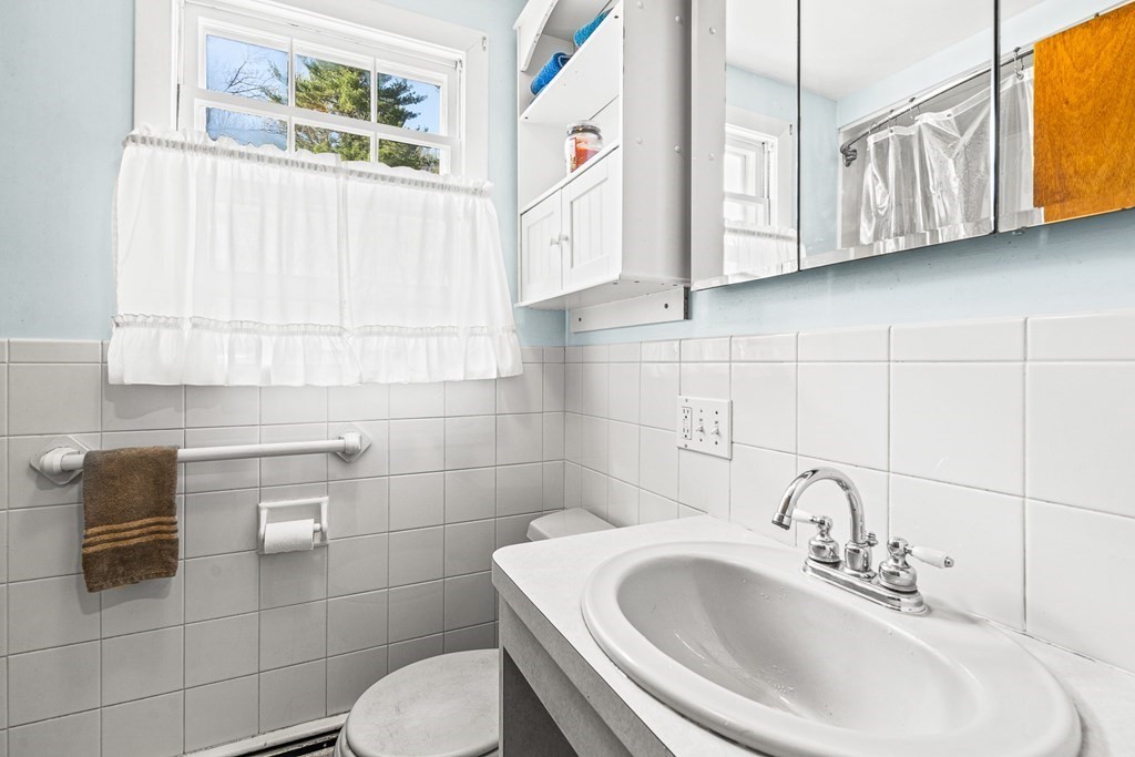 89 Willow Road Boxford, MA 01921 - Photo 12 of 22 a bathroom with a sink a toilet and mirror