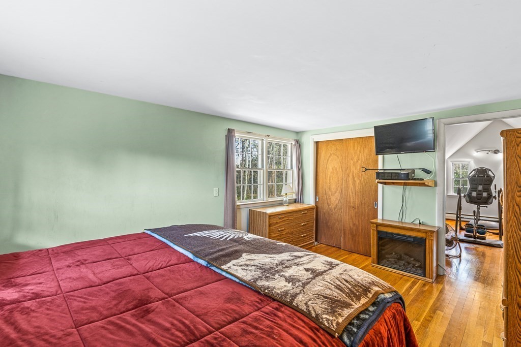 89 Willow Road Boxford, MA 01921 - Photo 9 of 22 a bedroom with a bed and wooden floor