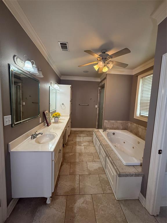 201 Woodhaven Drive Minden, LA 71055 - Photo 14 of 31 Spacious bathroom featuring a jetted soaking tub, dual vanity with undermount sinks, and stone tile flooring