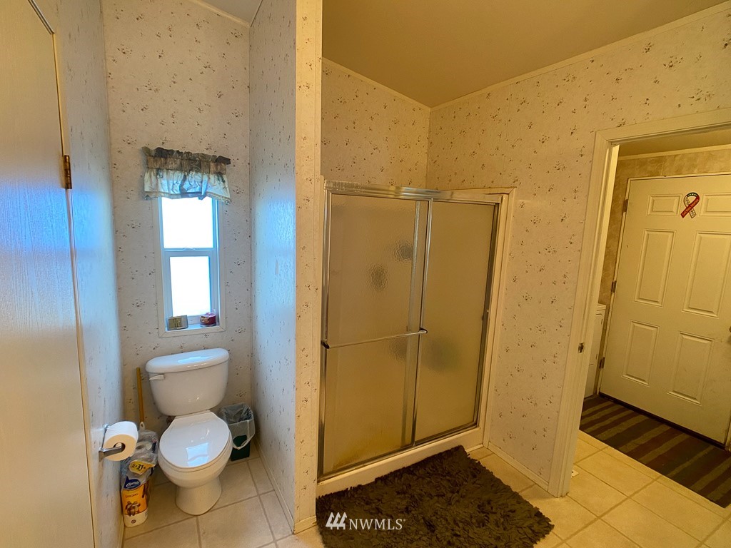 1104 Nooksack Road Nooksack, WA 98276 - Photo 20 of 33 a bathroom with a granite countertop toilet and a shower