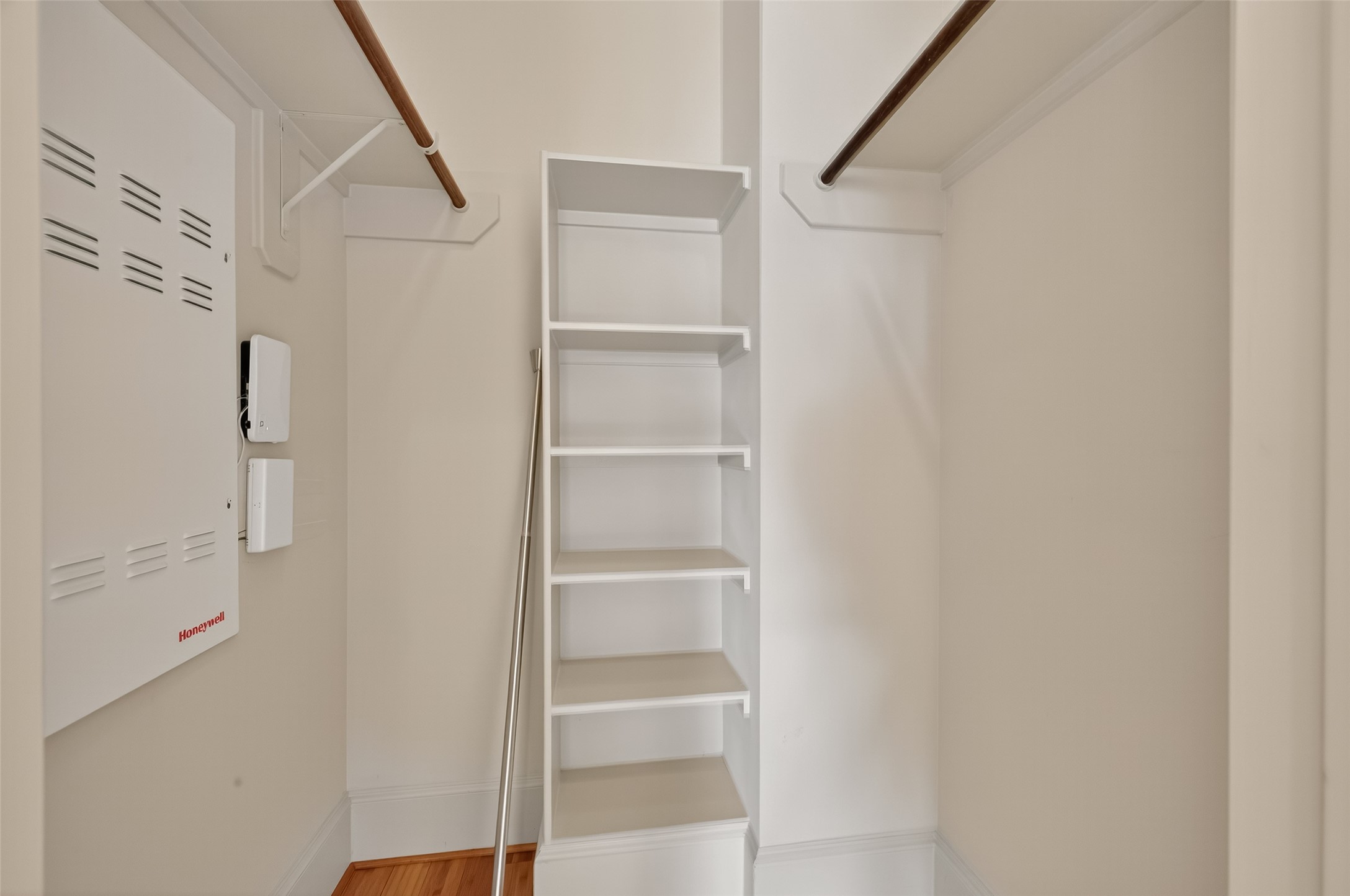 931 West 23rd Street, Unit K Houston, TX 77008 - Photo 24 of 40 Secondary bedroom walk-in closet with built-in shelving and hanign racks.