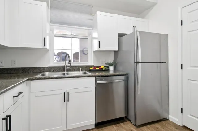 a kitchen with cabinets and steel stainless steel appliances