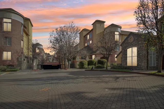 a view of a city street lined with buildings and trees