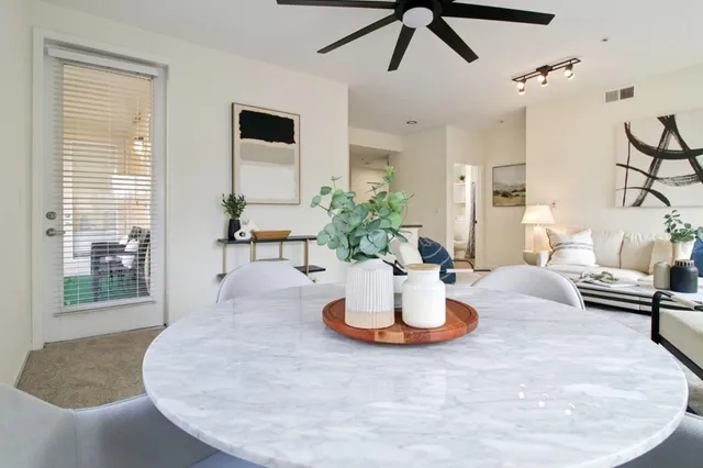a kitchen with stainless steel appliances granite countertop a sink and a refrigerator