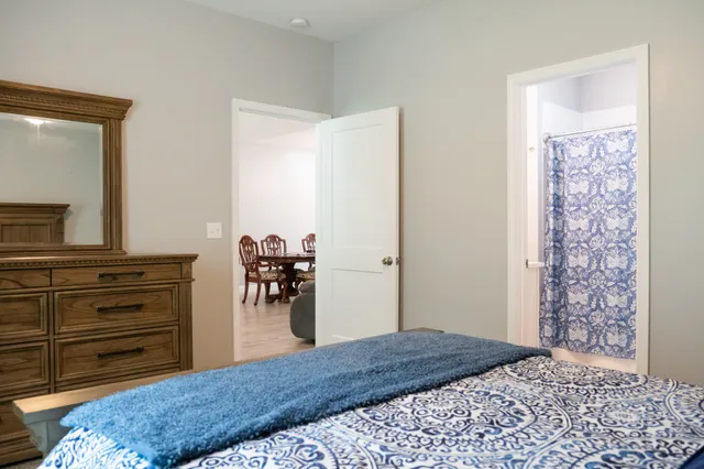 a bedroom with a bed and a chandelier