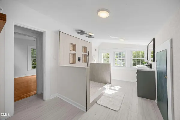a view of a kitchen with refrigerator and wooden floor
