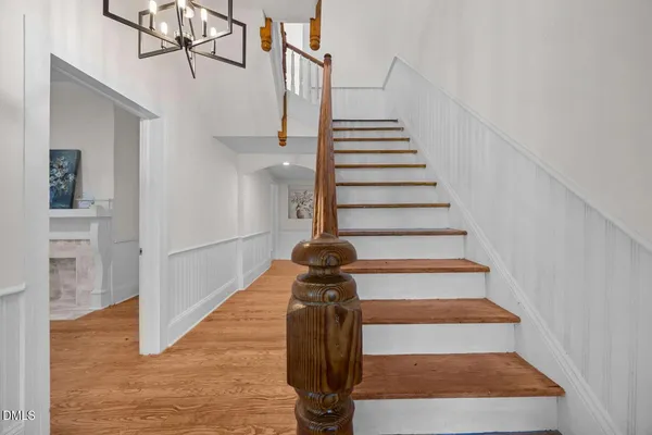 a view of entryway and hall with wooden floor