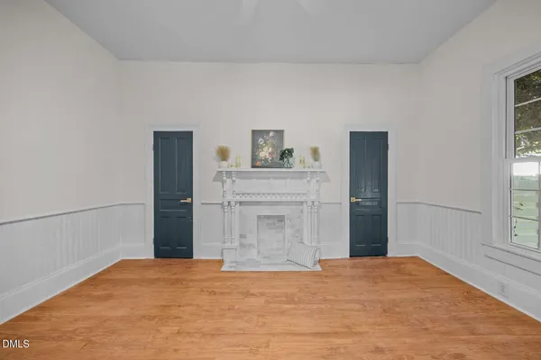 a view of empty room with cabinet and window