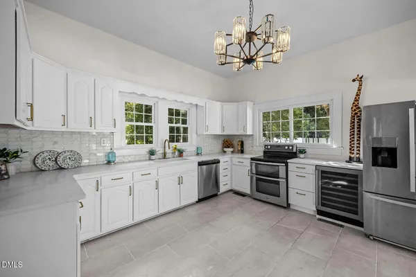 a kitchen with a stove a sink and a refrigerator