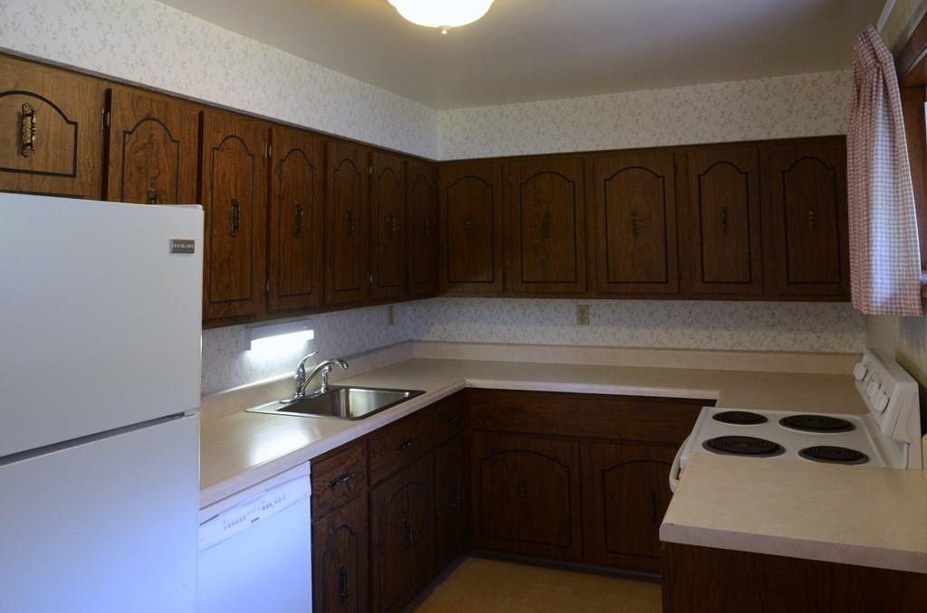 468 Lindsay Road Carnegie, PA 15106 - Photo 7 of 21 Large amount of cabinet space and counterspace with undercabinet lighting above the sink.