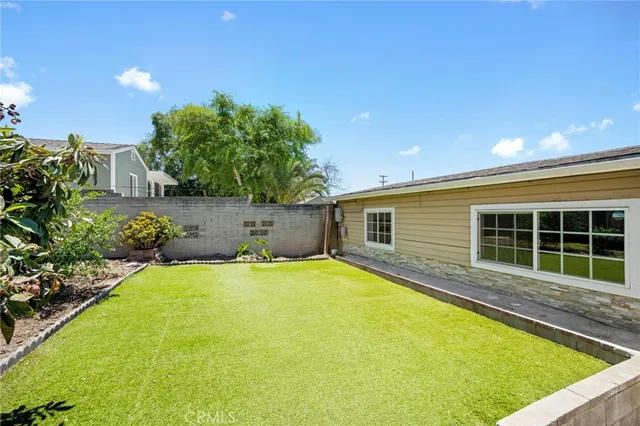 a view of a house with pool and a yard
