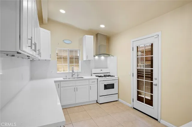 a kitchen with stainless steel appliances granite countertop a stove and a sink