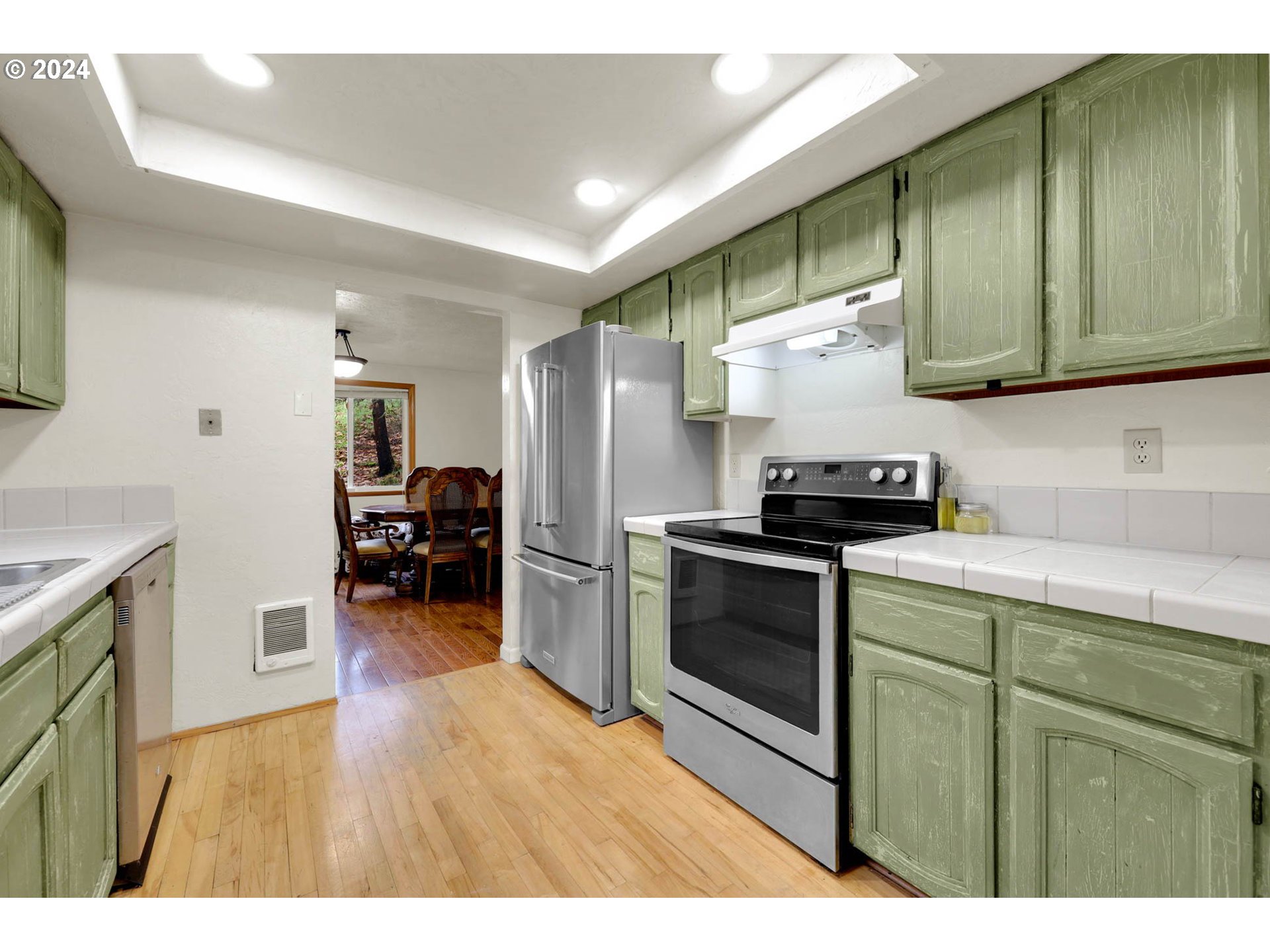 590 South 71st Street Springfield, OR 97478 - Photo 15 of 44 a kitchen with stainless steel appliances wooden cabinets and a stove top oven