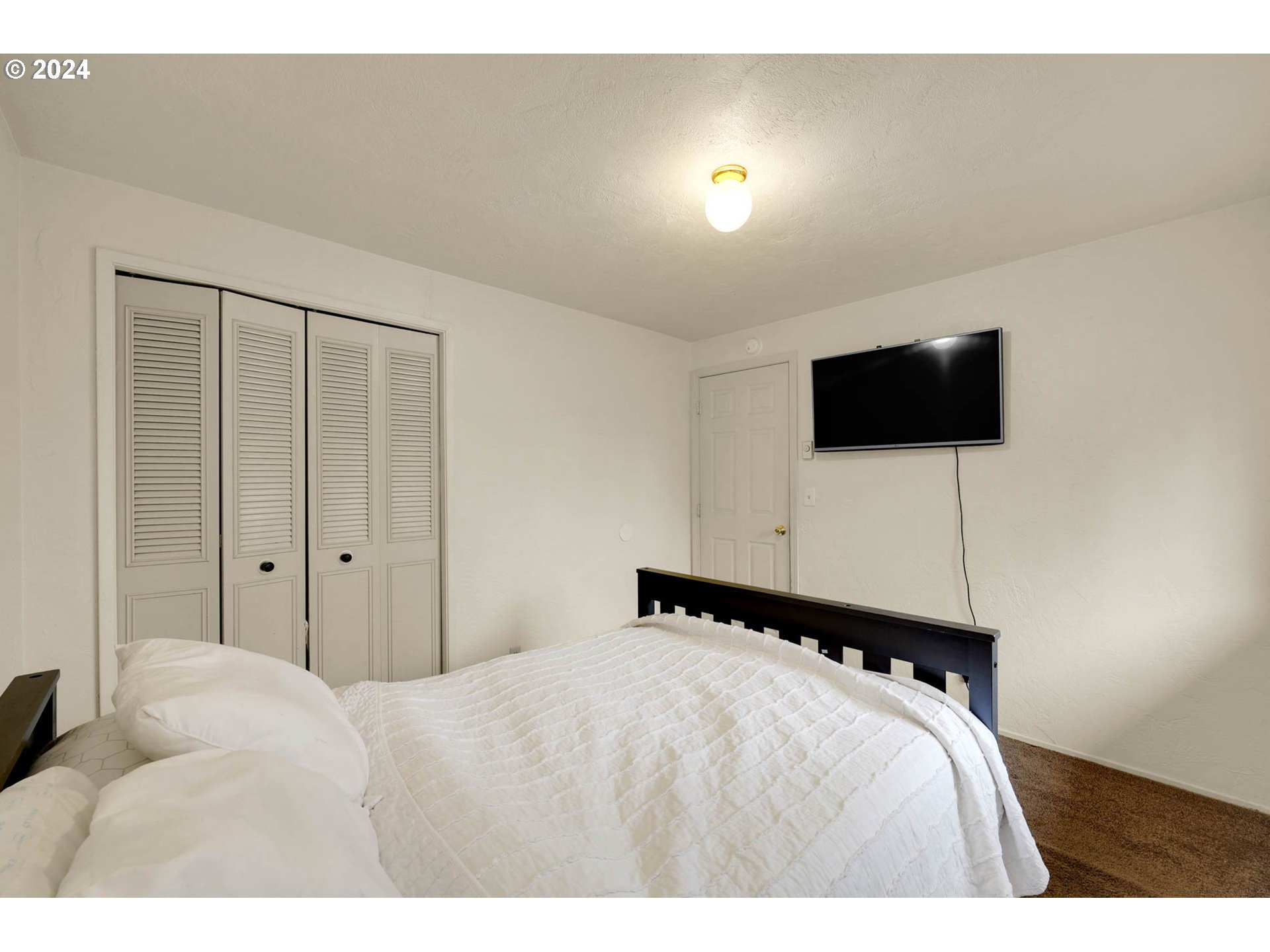 590 South 71st Street Springfield, OR 97478 - Photo 26 of 44 a bedroom with a bed and a flat screen tv
