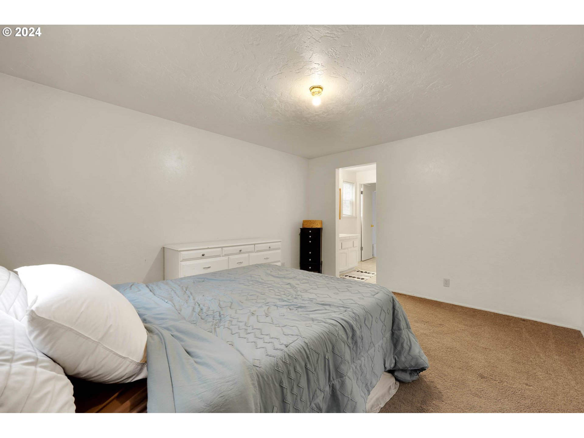 590 South 71st Street Springfield, OR 97478 - Photo 31 of 44 a bedroom with a bed and a night stand