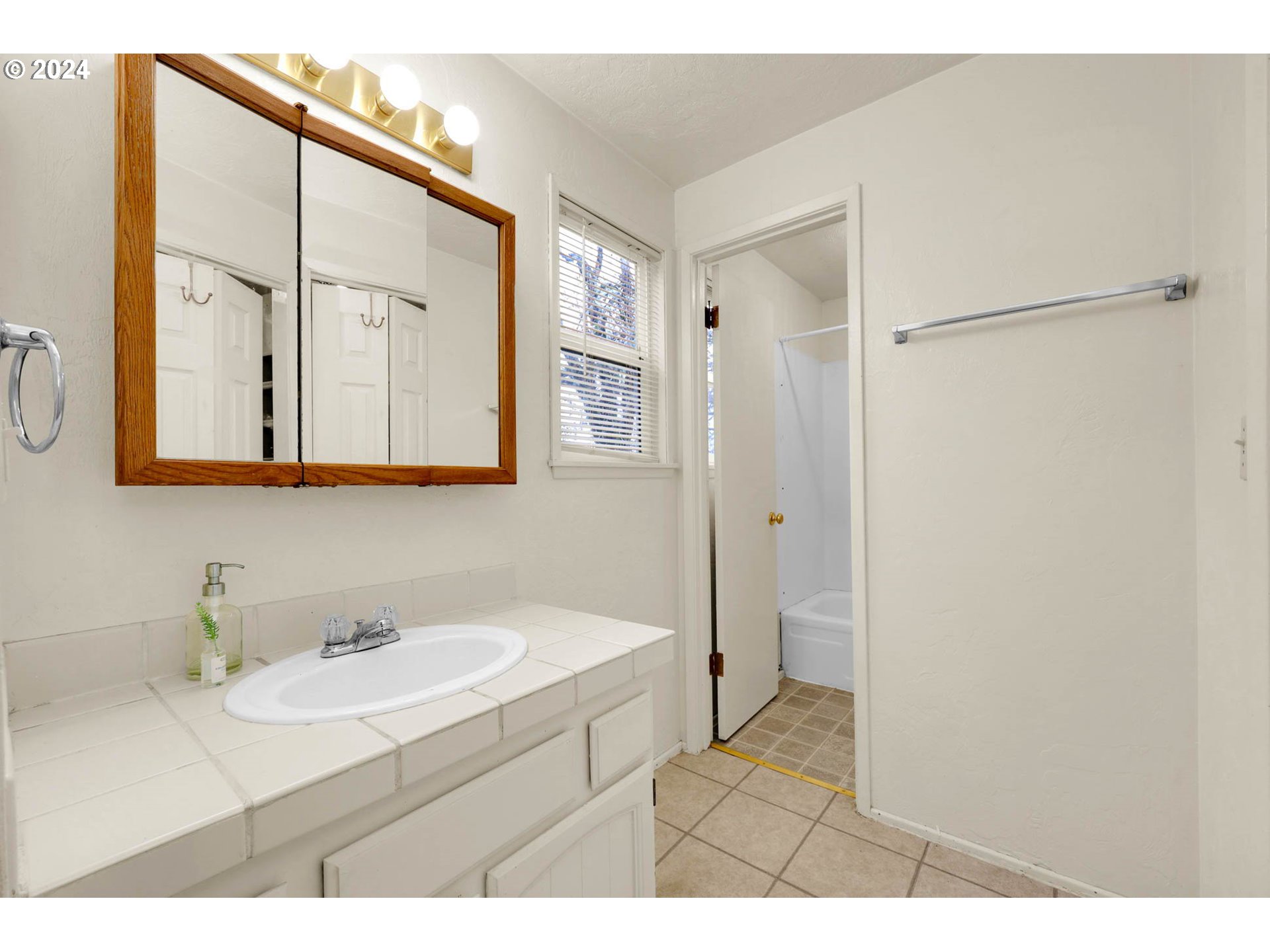 590 South 71st Street Springfield, OR 97478 - Photo 34 of 44 a bathroom with a sink mirror and a shower