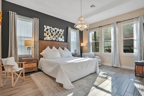 a living room with furniture dining table a chandelier and a rug