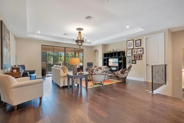 a living room with furniture fireplace and a large window