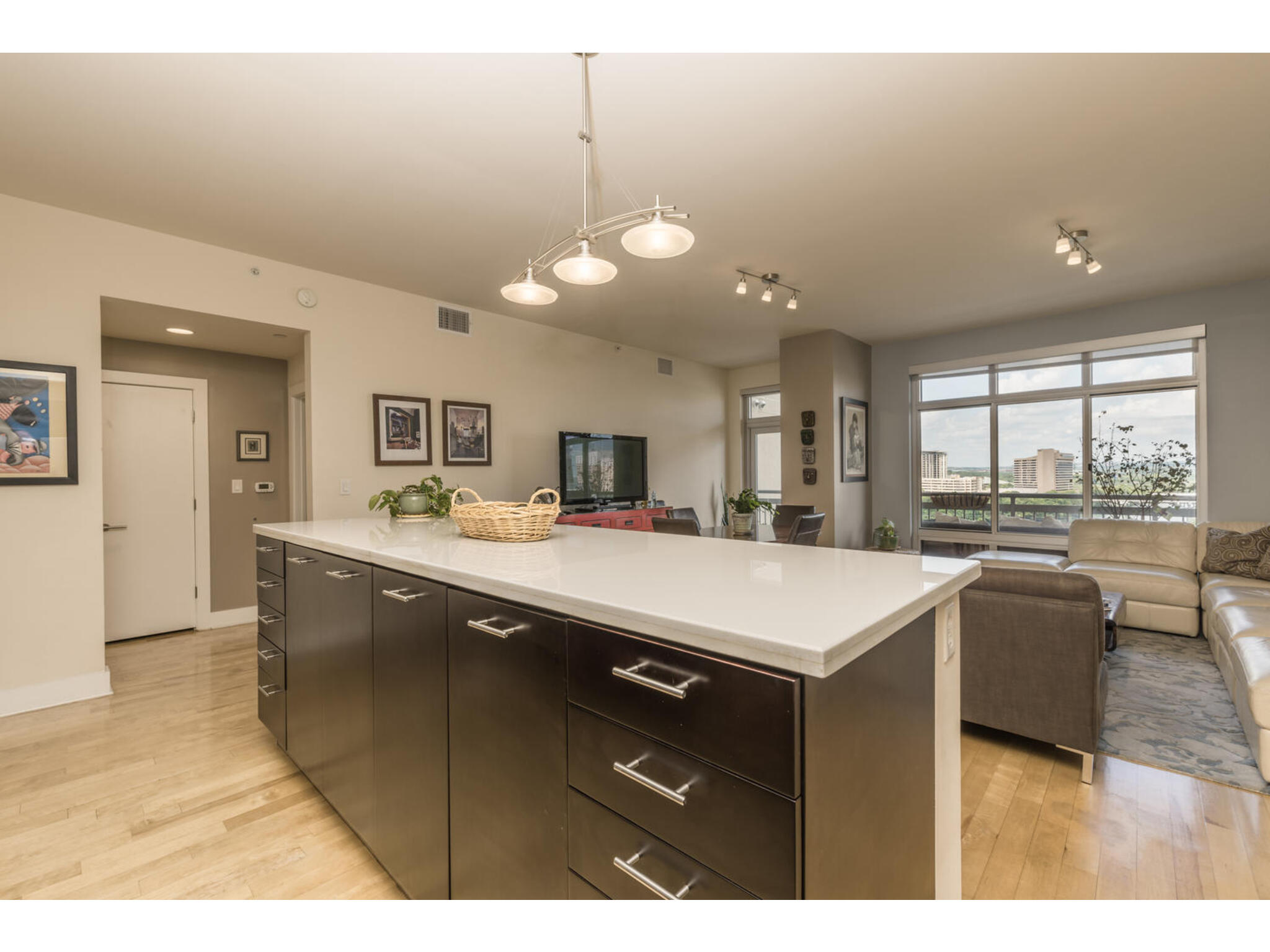 603 Davis Street, Unit 902 Austin, TX 78701 - Photo 21 of 21 Kitchen with open floor plan, a kitchen island, light wood-style flooring, and track lighting