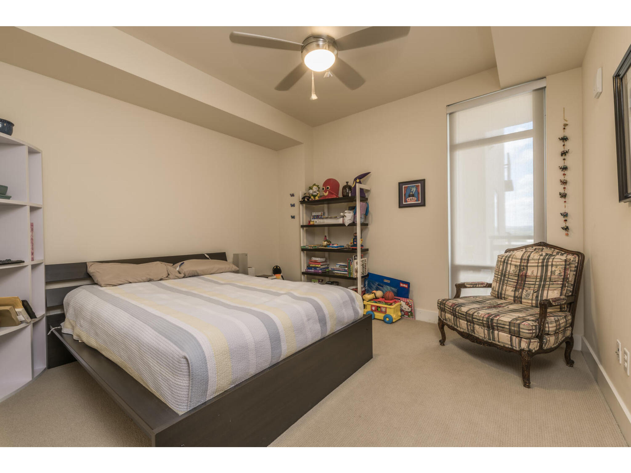 603 Davis Street, Unit 902 Austin, TX 78701 - Photo 13 of 21 Bedroom with light carpet and ceiling fan