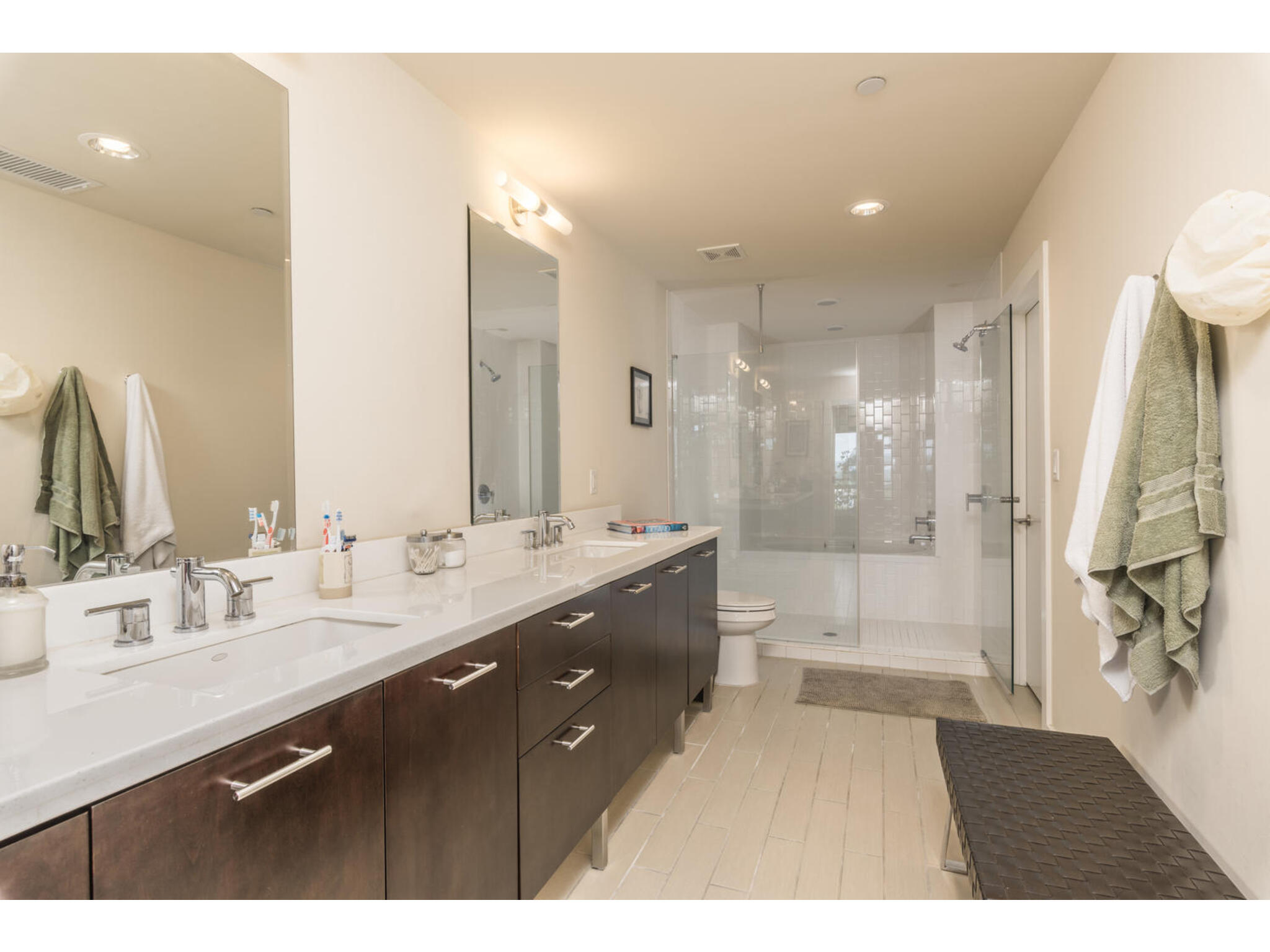603 Davis Street, Unit 902 Austin, TX 78701 - Photo 17 of 21 Bathroom featuring double vanity, a stall shower, and recessed lighting
