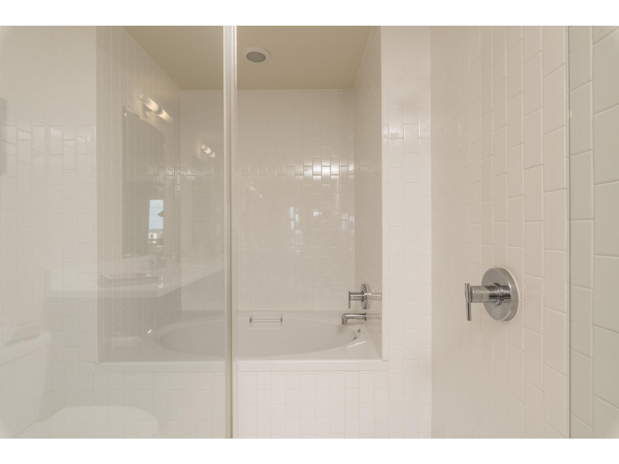 603 Davis Street, Unit 902 Austin, TX 78701 - Photo 18 of 21 Full bath with a garden tub and a tile shower