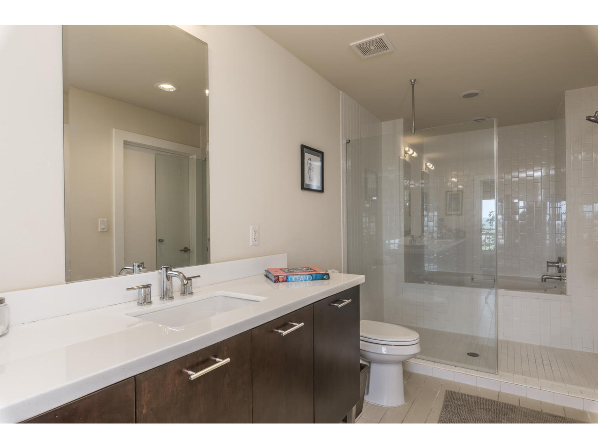 603 Davis Street, Unit 902 Austin, TX 78701 - Photo 20 of 21 Bathroom with vanity, a stall shower, light tile patterned flooring, and recessed lighting