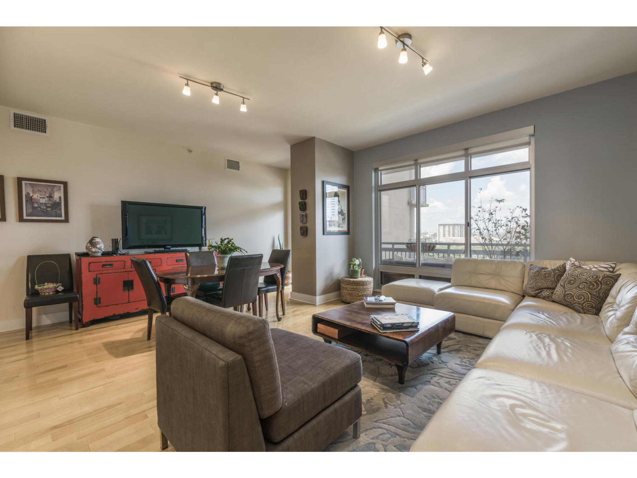 603 Davis Street, Unit 902 Austin, TX 78701 - Photo 9 of 21 Living room featuring light wood-type flooring and track lighting