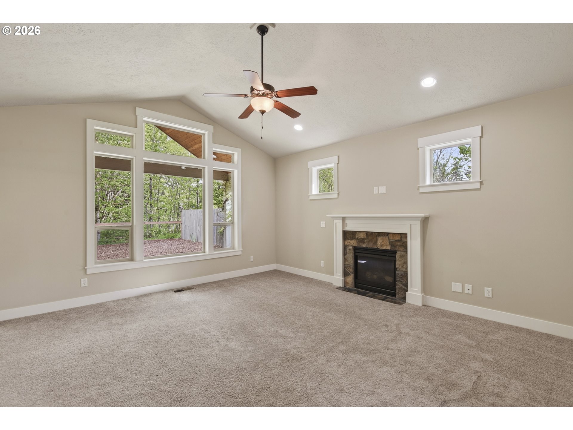 37437 Southeast Olson Street Sandy, OR 97055 - Photo 11 of 48 a view of empty room with fireplace and windows