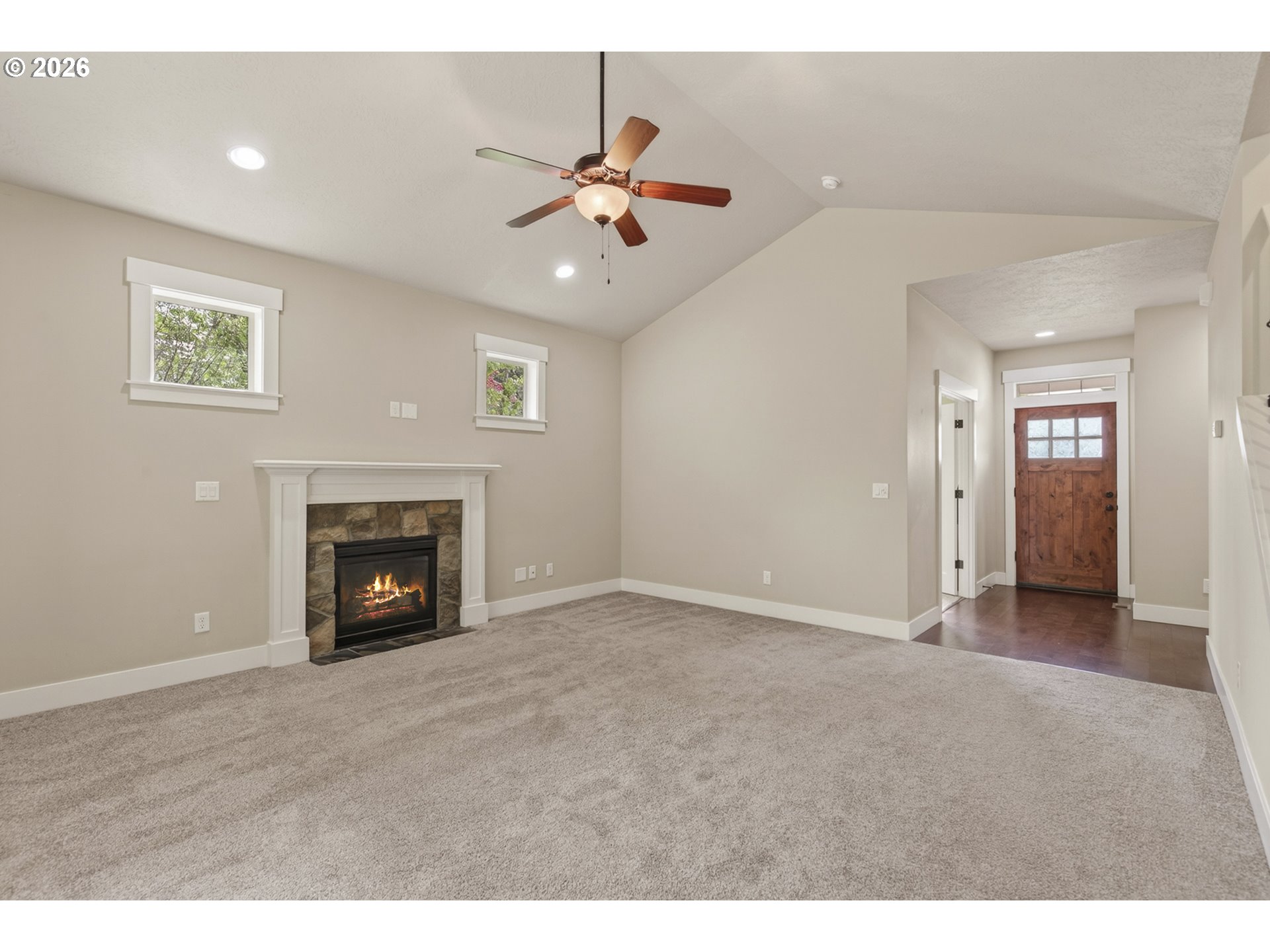 37437 Southeast Olson Street Sandy, OR 97055 - Photo 8 of 48 a view of an empty room with chandelier fan and fire place