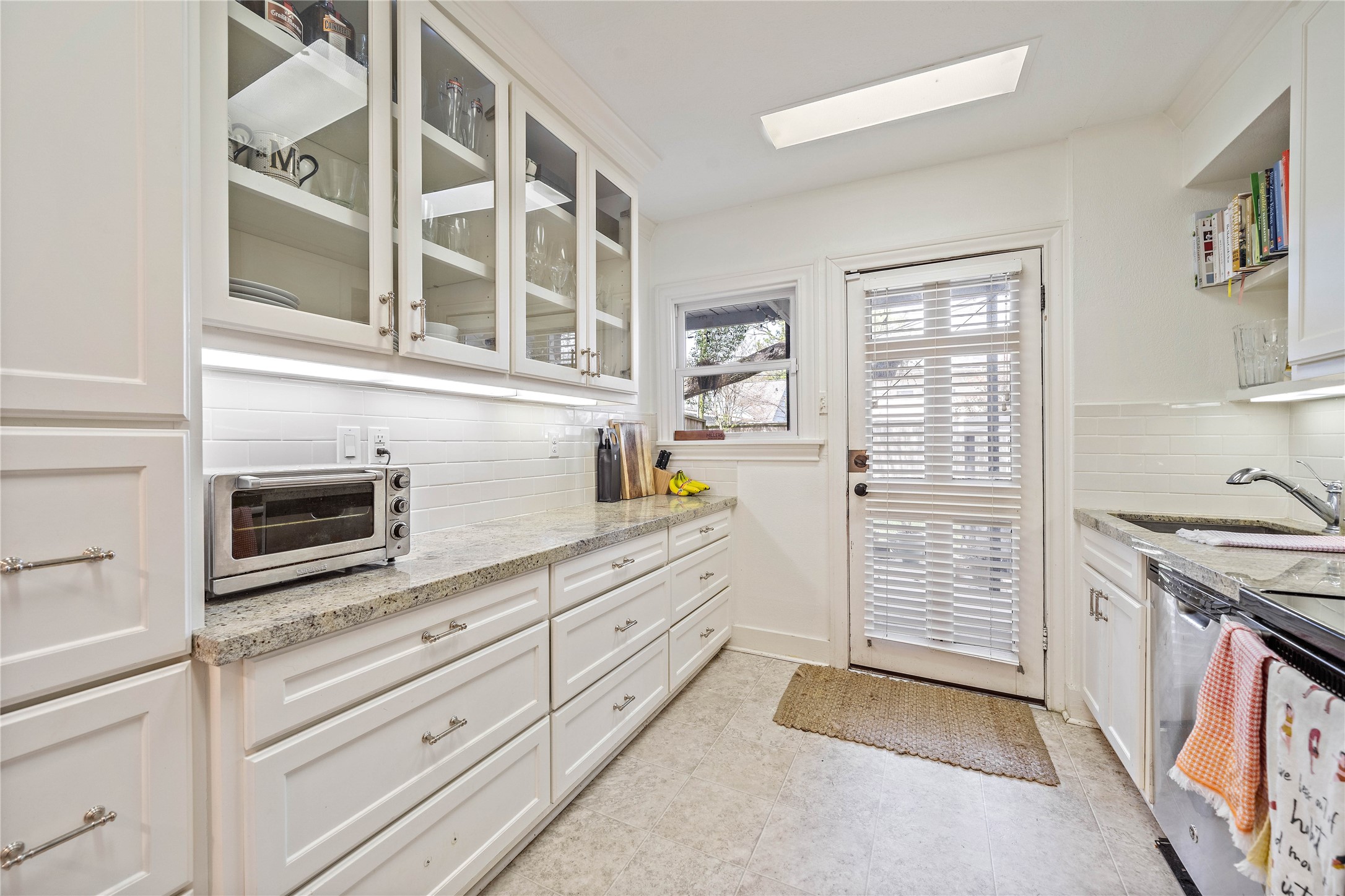 2324 Goldsmith Street, Unit A Houston, TX 77030 - Photo 13 of 30 a kitchen with stainless steel appliances cabinets and a window