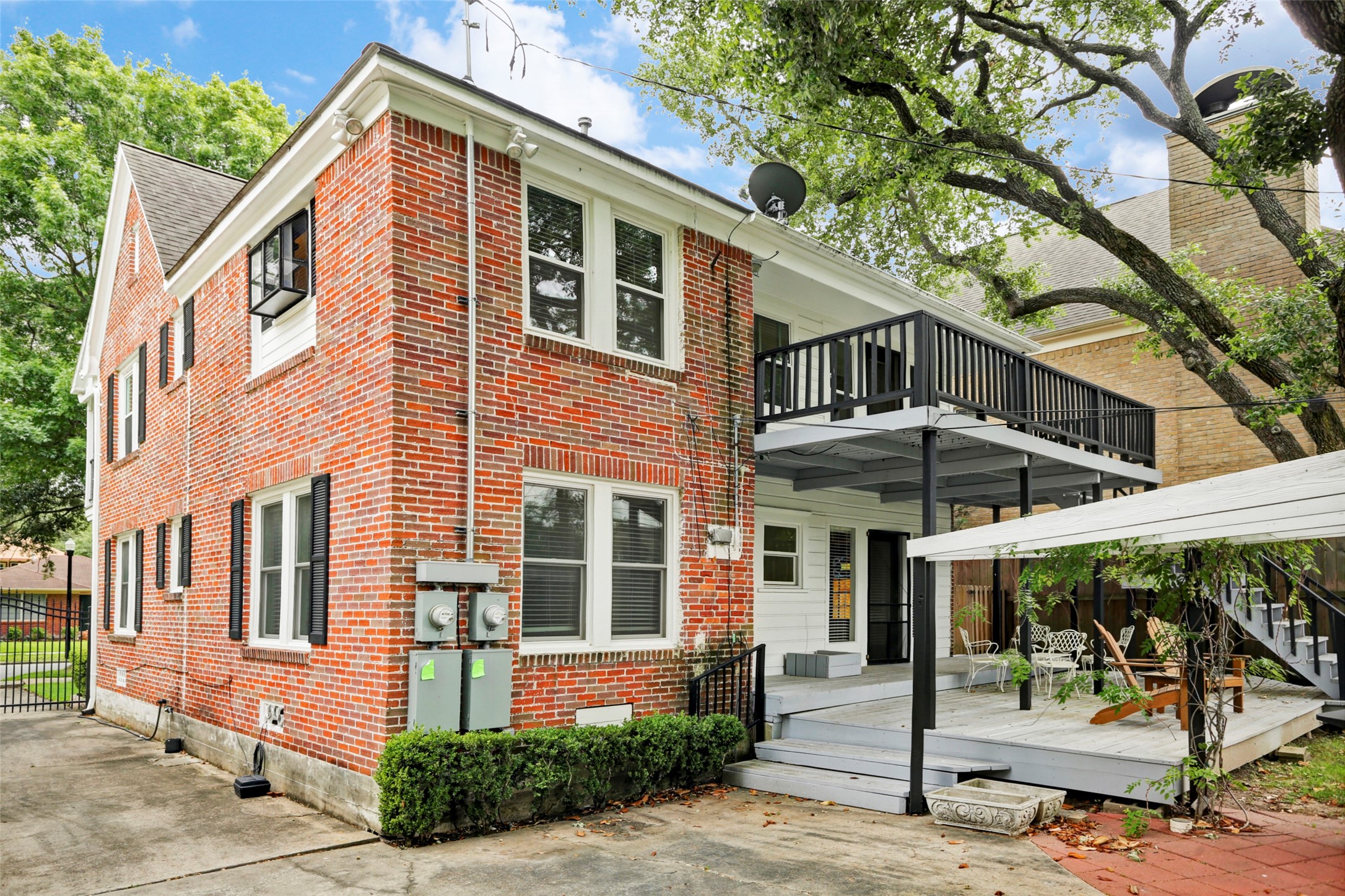 2324 Goldsmith Street, Unit A Houston, TX 77030 - Photo 25 of 30 a front view of a house with a yard glass top table and chairs under an umbrella